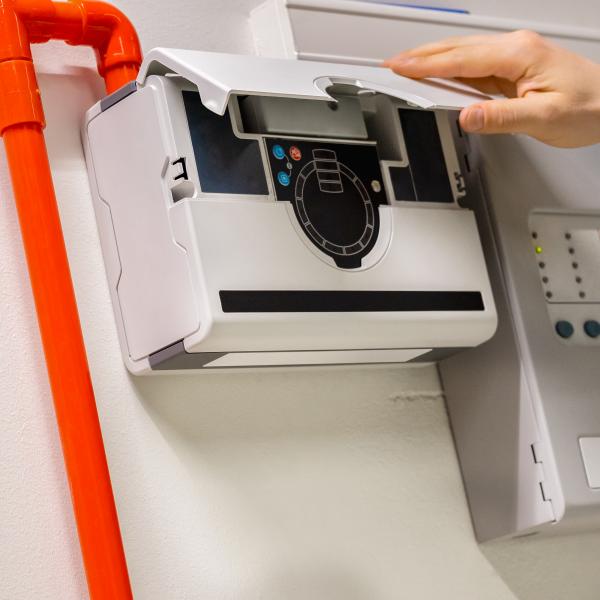 Technician checking smoke sensor pannel.