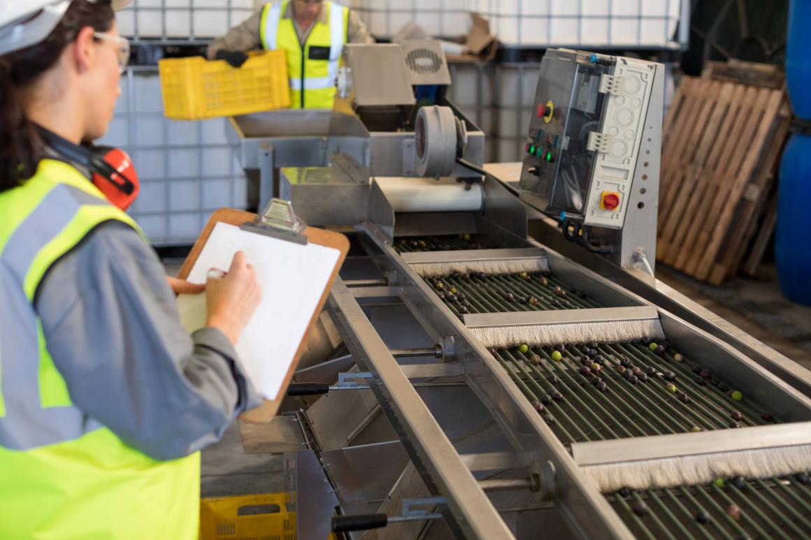Female technician writing on clipboard.